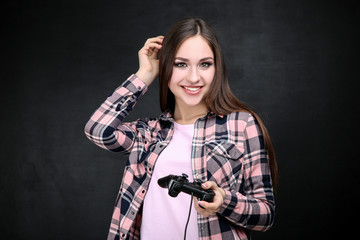 Beautiful girl with joystick on black background
