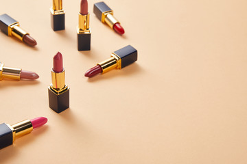 Obraz premium various red shades of lipsticks on beige