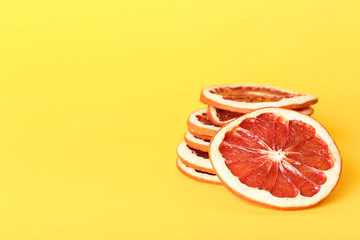 Dried grapefruits on yellow background