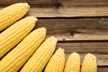 Ripe corn on brown wooden table
