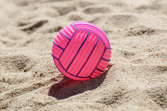 beach volleyball ball at the beach .Pink ball