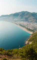 Fototapeta na wymiar Panorama of the old town overlooking the beach. View of the resort town. Alanya is popular tourist destination in Turkey. Panorama in high resolution observed from Fortress of Alanya