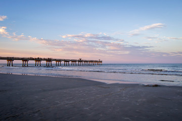 Sunset over Atlantic ocean with pier