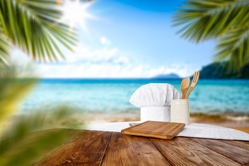 Summer beach and desk of free space with cook hat 