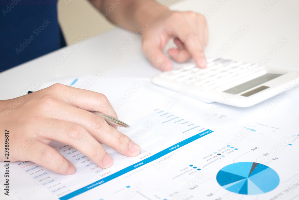 Poster close-up to the hands of businessmen working on the desk using a calculator to calculate numbers. fi