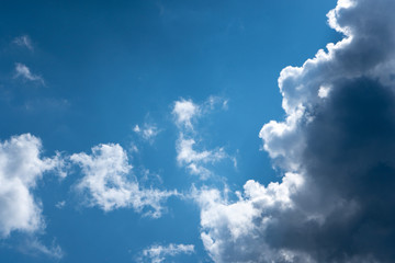 Luminous clouds set against a dark blue sky in the sun. Wonderful blue glowing cloud