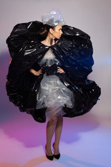 Girl posing in a dress made of plastic film. Fashion portrait.