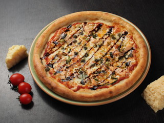 Pizza with salmon, onions and cheese on a plate