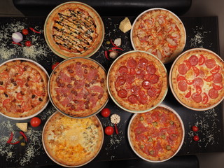 Variety of pizza on the table, top view