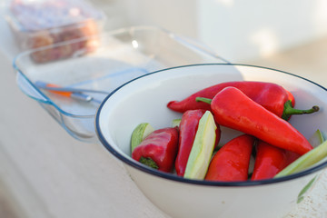 Red sweet pepper and pieces of zucchini lies in a bowl