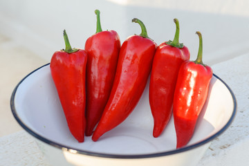 Red sweet pepper lies in a bowl