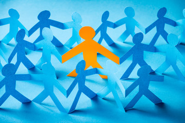 Paper cut concept - being part of the group. One different person in the group with others.