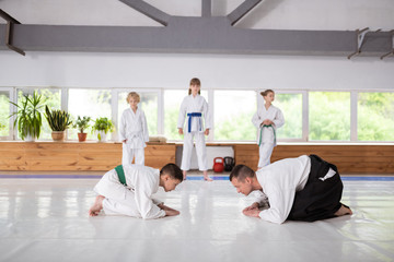 Boy and aikido trainer greeting each other before practicing