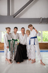 Boys and girls hugging trainer after amazing time together