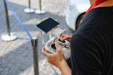 Professional videographer holding remote control for drone