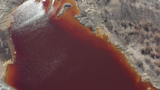 Huge hill of iron sulfide pyrite and red waste water 4K drone video