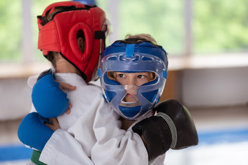 Dark-eyed boy wearing protective helmet battling with friend