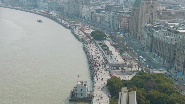 Crowd of People on Bund Waterfront. Shanghai City, China. Aerial Shot. Drone is Oribitng