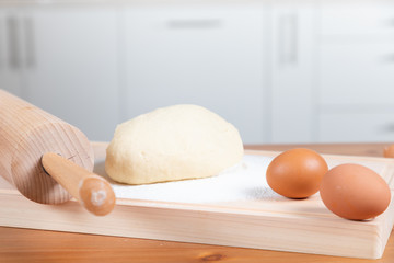 Dough and ingredients on the kitchen table