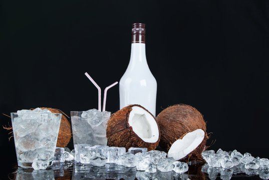 coconut with ice cubes on a black background