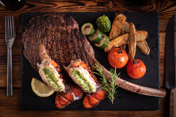 surf and turf with tomahawk rib eye steak and lobster tail