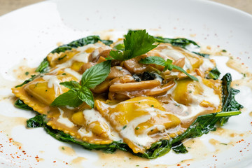 close up of home made porcini mushrooms ravioli with spinach