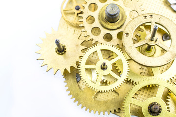 The mechanism of the old bronze gears isolated on a white background.