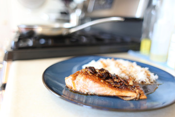 Plate of steelhead trout with teriyaki demi-glace and rice.