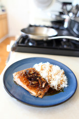 Plate of steelhead trout with teriyaki demi-glace and rice.
