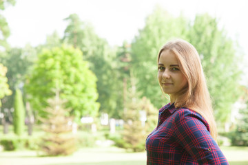 Attractive young woman in a summer park