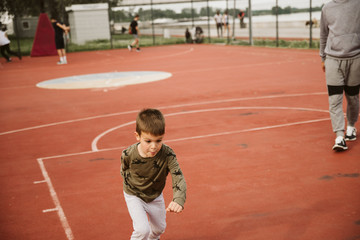 Fototapeta premium A little boy on a basketball court