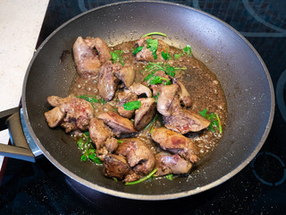 chicken liver with herbs are frying in pan