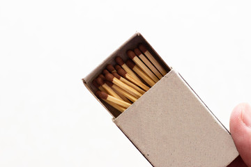 outdoor matchboxes closeup on white background. Matchbox in hand. Open matchbox in hand