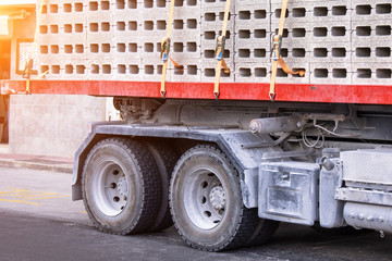 Back truck with a fully loaded body of concrete blocks with cement.
