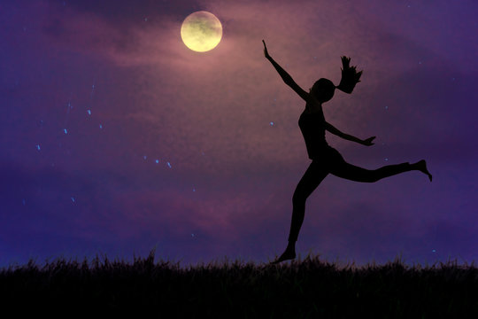 Silhouette, a young woman clutching the moon in open grassland, concept pursues dreams.