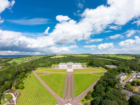 Aerial View Of Stormont Parliament Buildings In Belfast Northern Ireland. Green Fields Against Blue Sky 