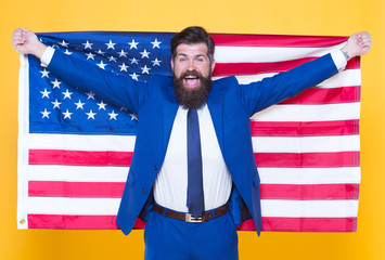 American by birth. Rebel by choice. Businessman concept. Confident businessman handsome bearded man in formal suit hold flag USA. Successful businessman well groomed appearance. Business people