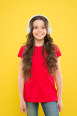 The only music that matters. Adorable girl enjoying music on yellow background. Little child listening to music in stereo headphones. Music education for small children