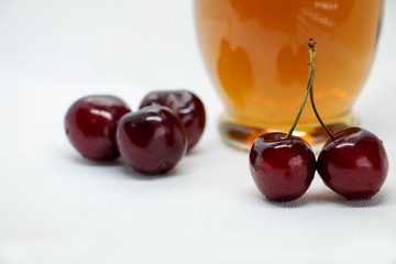 Bunches of sweet cherries and a bottle of juice