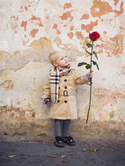 retro style. happy birthday. wedding. little boy in vintage coat. Beauty. small kid has red rose....