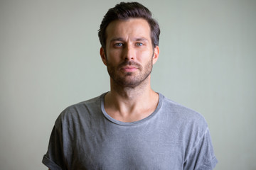 Face of handsome bearded man looking at camera