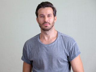 Studio shot of handsome bearded man looking at camera