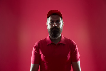 Free cashier. Restaurant cafe staff wanted. First job. Man bearded hipster wear cap and cashier uniform red background. Regular cashier concept. Salesman and cashier career. Hiring shop store worker