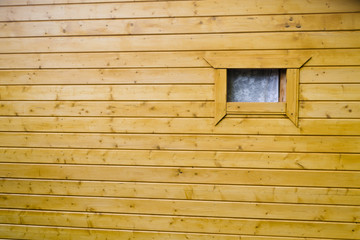 Obraz na płótnie Canvas Window on the yellow wooden building facade in countryside, open window in the street. Minimal composition. Rustic wallpaper concept