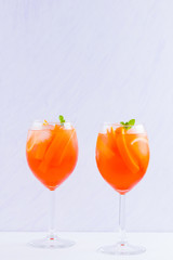 Aperol Spritz cocktail with mint leaves on a white background. Italian cocktail aperol spritz on white