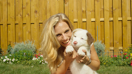PORTRAIT: Gorgeous blonde girl playing in the backyard with her adorable puppy.