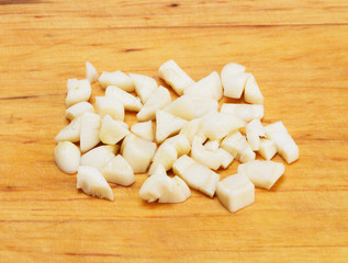 Chopped garlic on wooden background with copy space