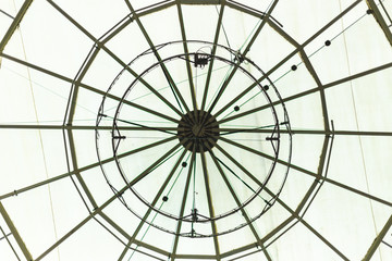 Round glass roof of a building interior – Circular window from a construction interior used for ventilation – Beautiful decorative dome of s gallery or mall-