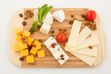 Various types of cheese composition on wooden board. Top view