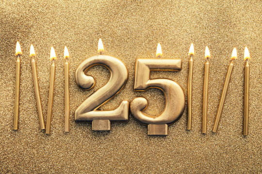 Number 25 gold celebration candle on a glitter background - Powered by Adobe